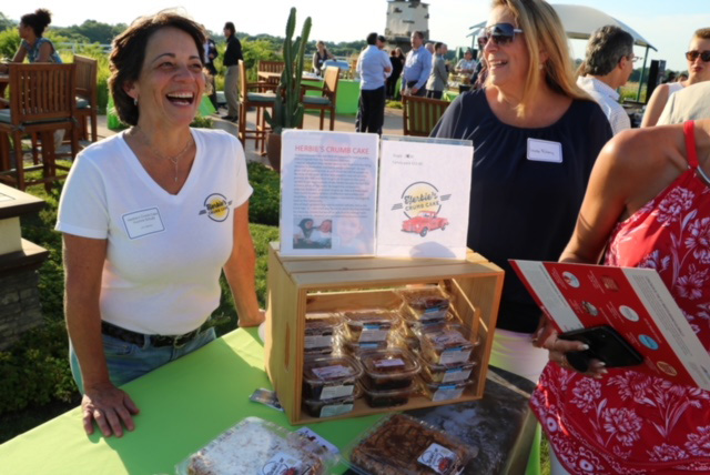 small business owner displaying her product at an outdoor event.