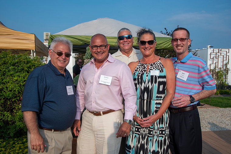 Michael Tucker with LI busiess owners on the rooftop summer celebration